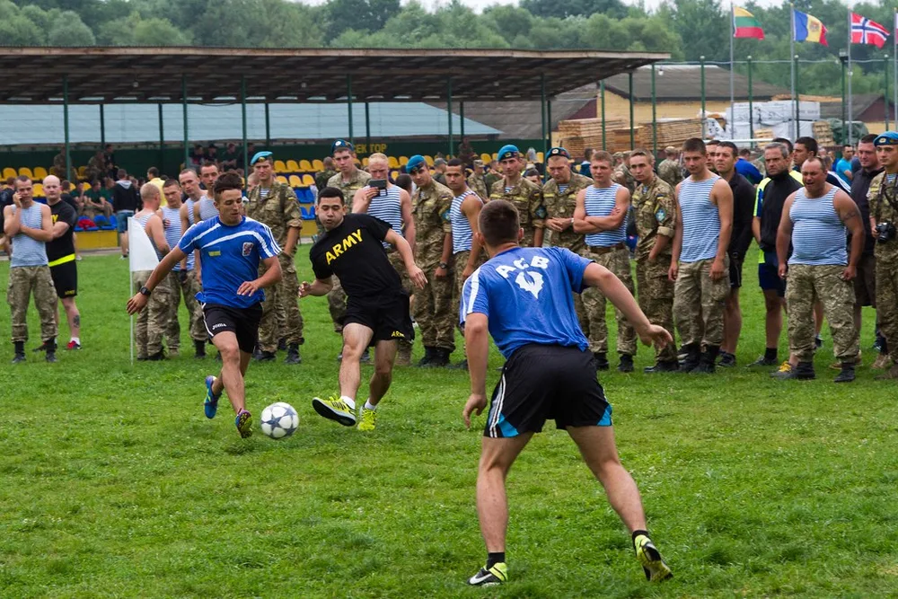 Close up shot of a youth football training ground, groups of young players pract