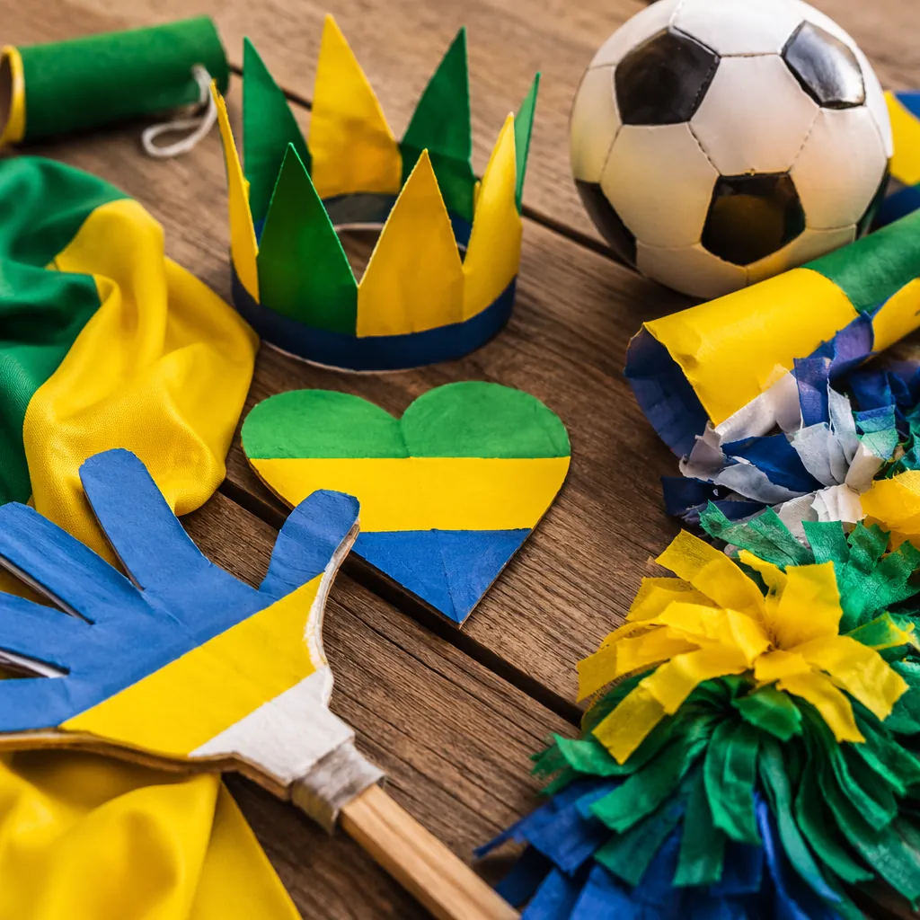 Handmade creative football fan props laid out on a wooden table, bright World Cu