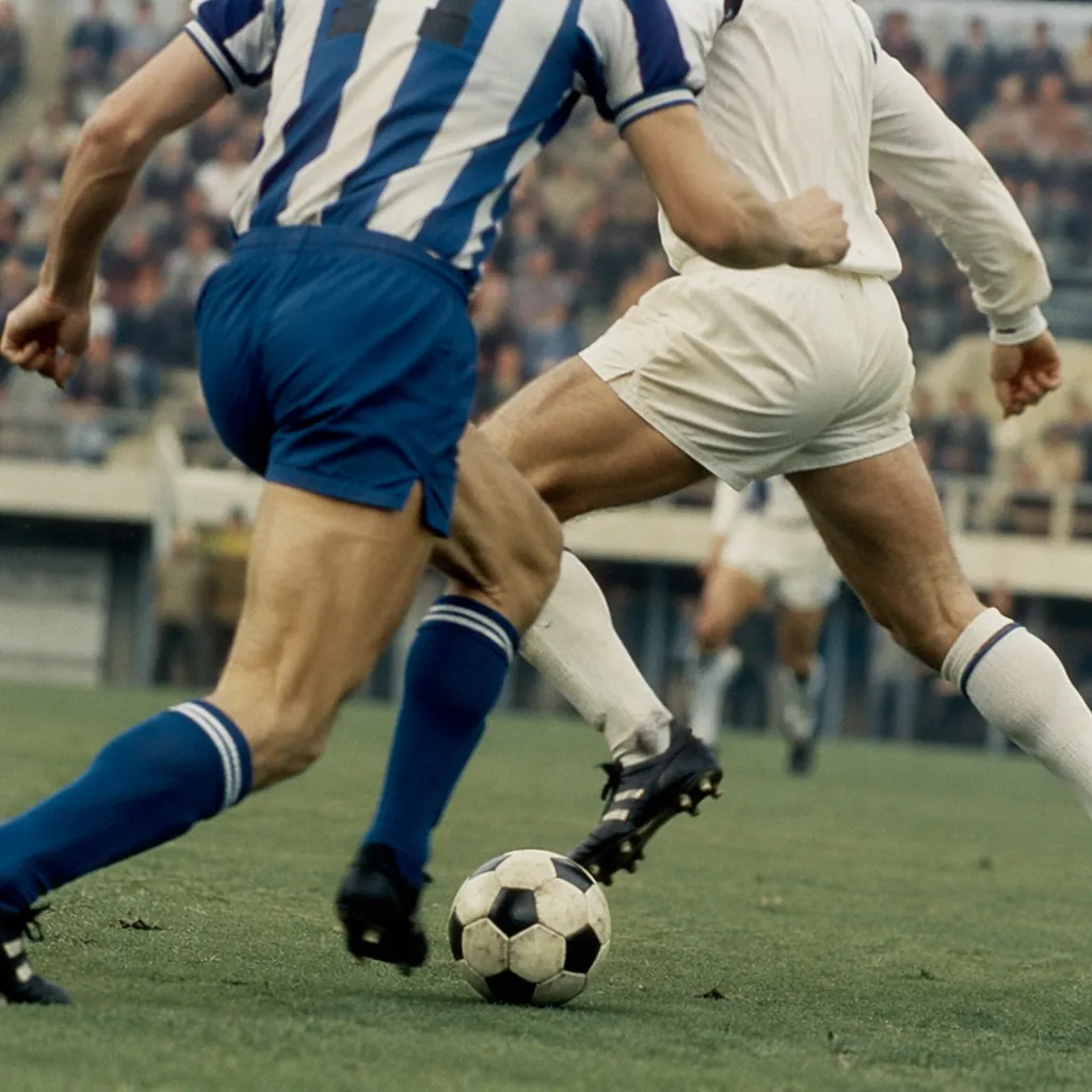 Vintage style football match action shot with generic players in blue and white 