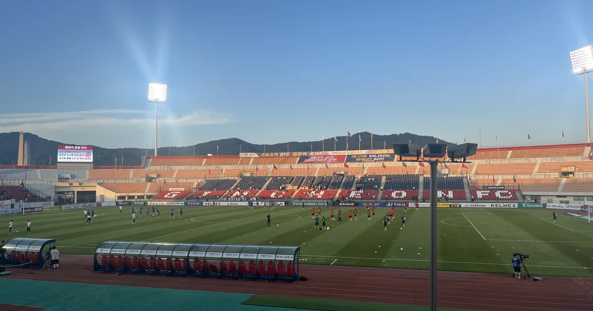 Professional sports news header image, blurred football stadium background with VAR monito