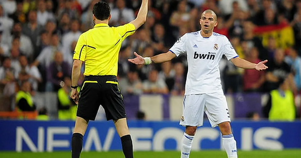 A wide shot of a professional soccer stadium during a World Cup match, with blurred player