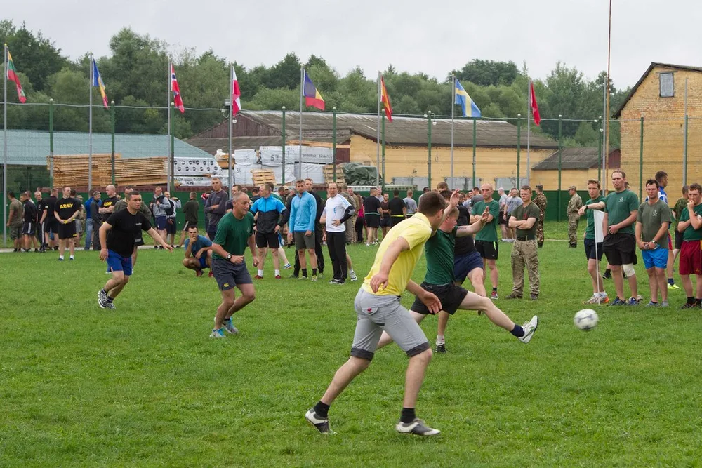 Close up shot of generic football training equipment on green grass, including f
