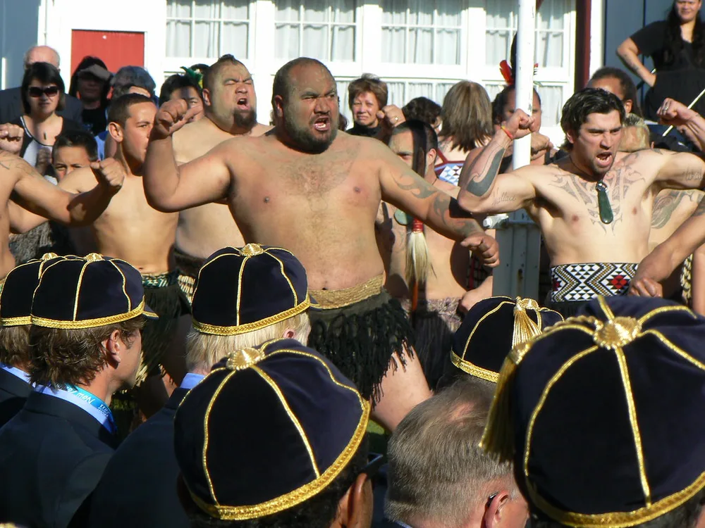 Group of generic football players huddling together during training, blurred fac