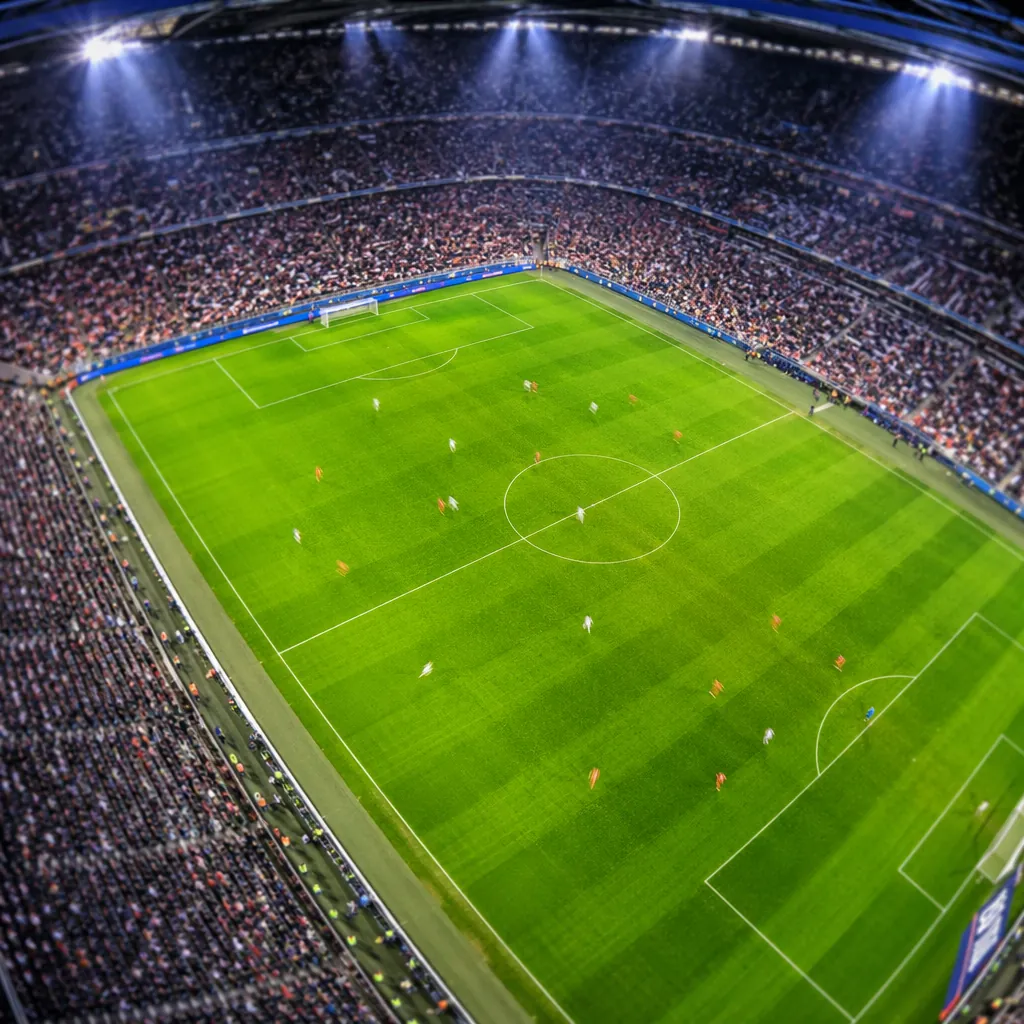 High angle shot of World Cup football pitch during match, blurred players in mot