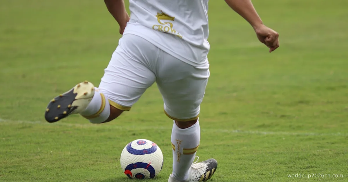 a man in a uniform kicking a soccer ball