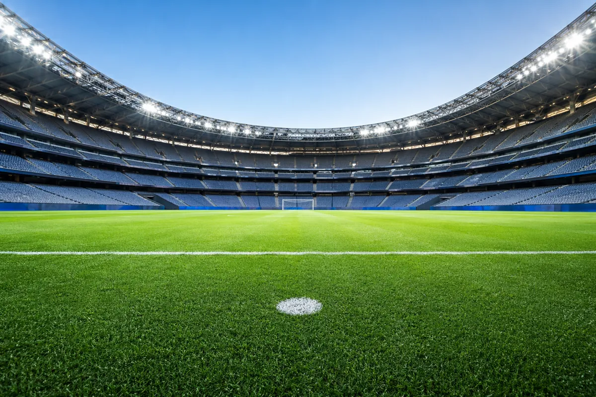 Wide shot of a football penalty spot in a large world cup stadium, bright stadium floodlig