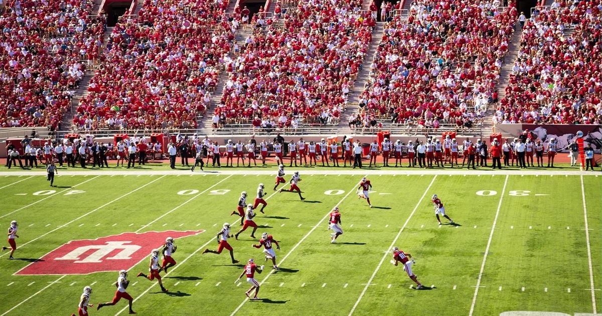 Professional football editorial header image, blurred modern football stadium background w
