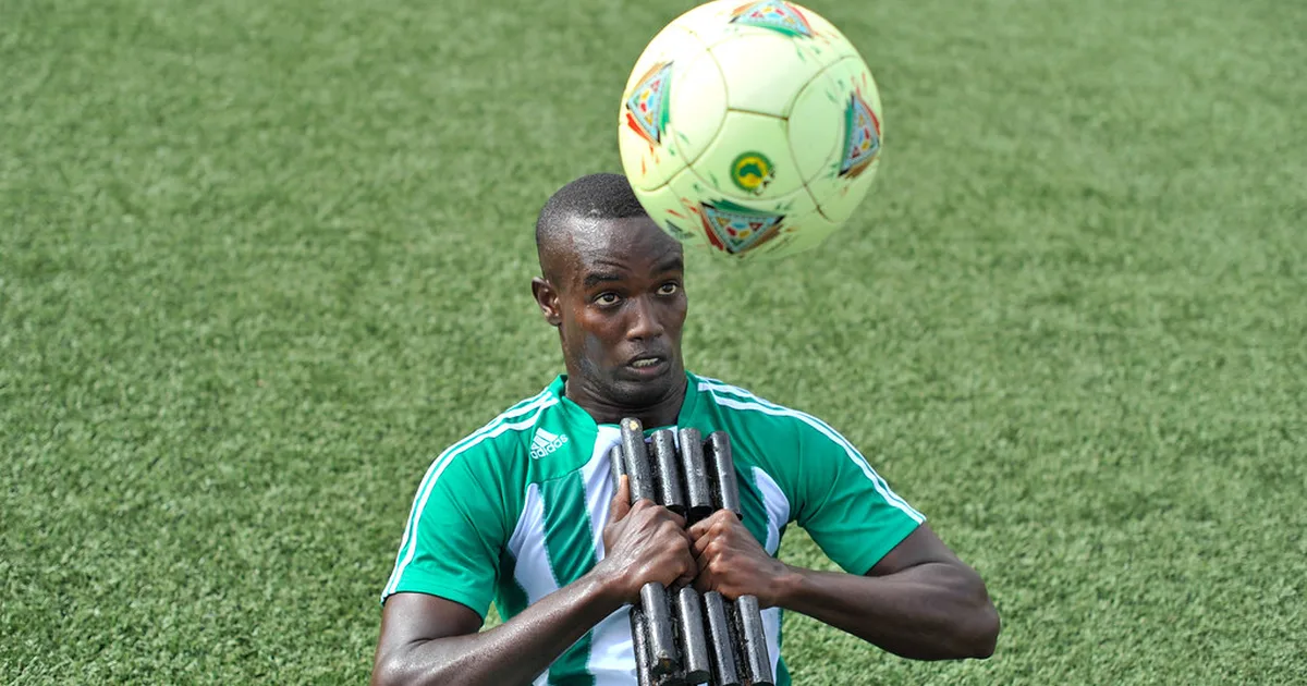 Professional football match scene, left back player running along the sideline, blurred st