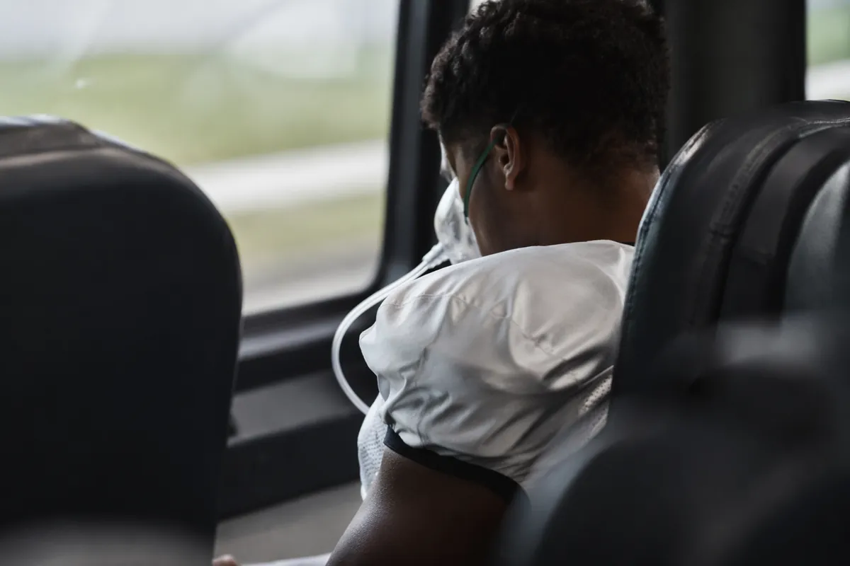 Professional sports news header image, blurred view of a football player wearing an oxygen