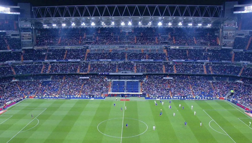 Wide shot of a modern FIFA World Cup football stadium with well-maintained green