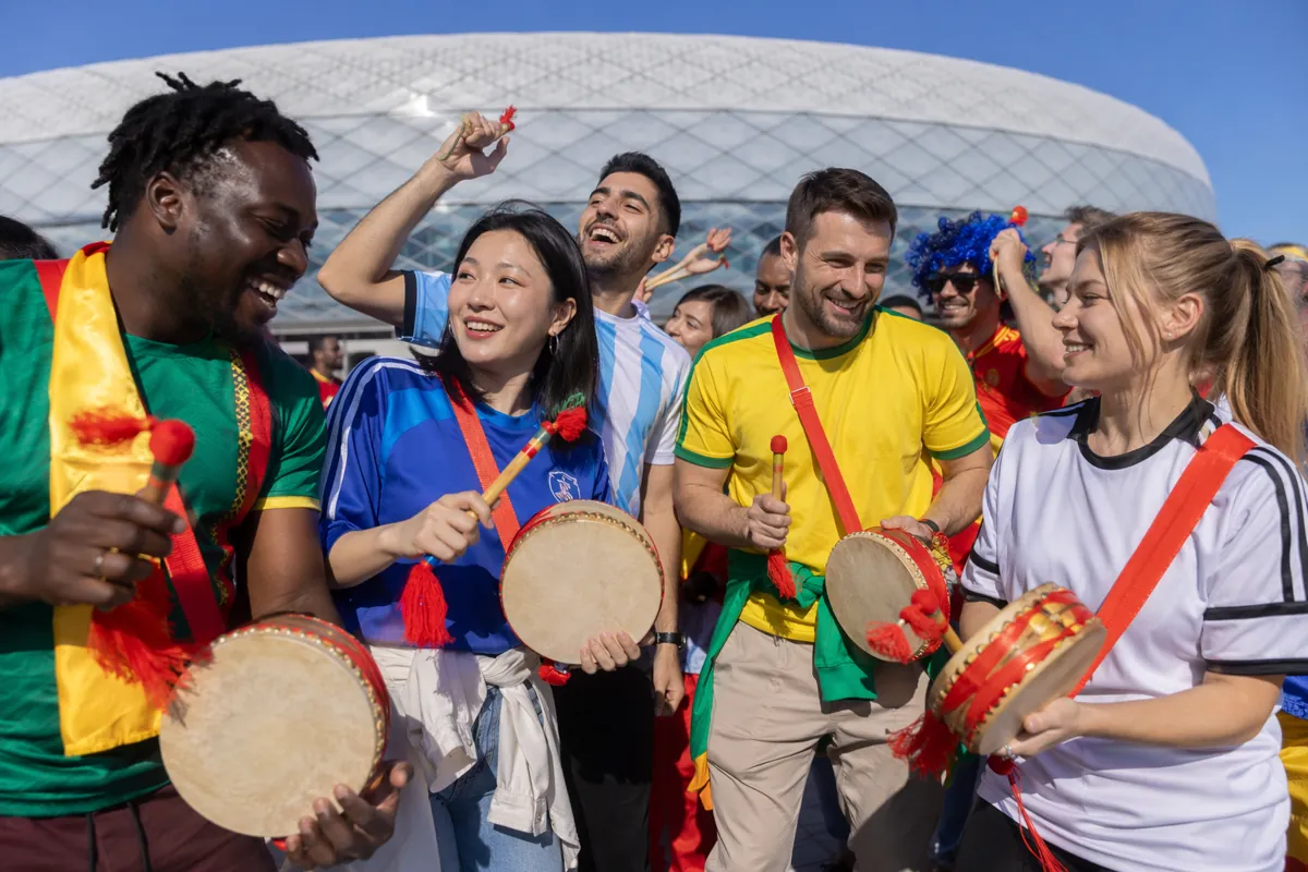 A diverse group of football fans from different countries playing traditional Chinese ratt