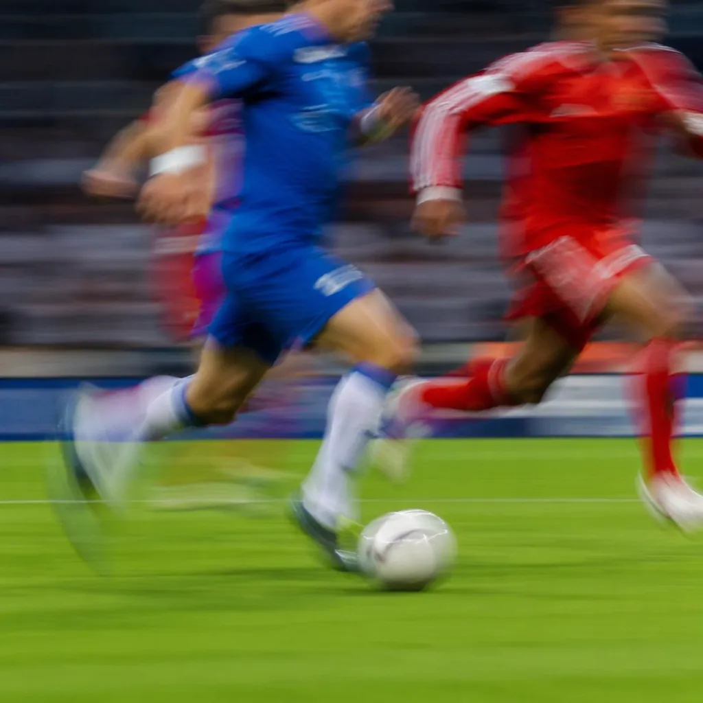 Blurred shot of football players running fast during a match, motion blur effect