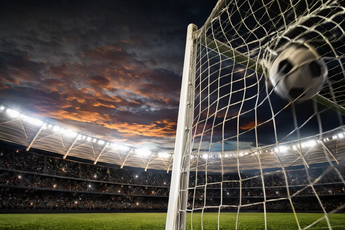 Professional editorial news photo of a World Cup stadium at dusk, bright floodlights illum