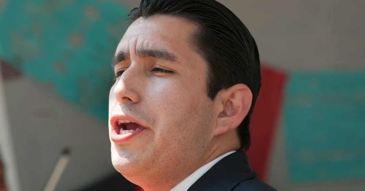 Editorial style photo of a professional football manager standing at a press conference po